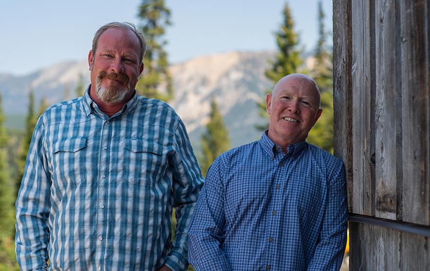 two older men smiling outdoors